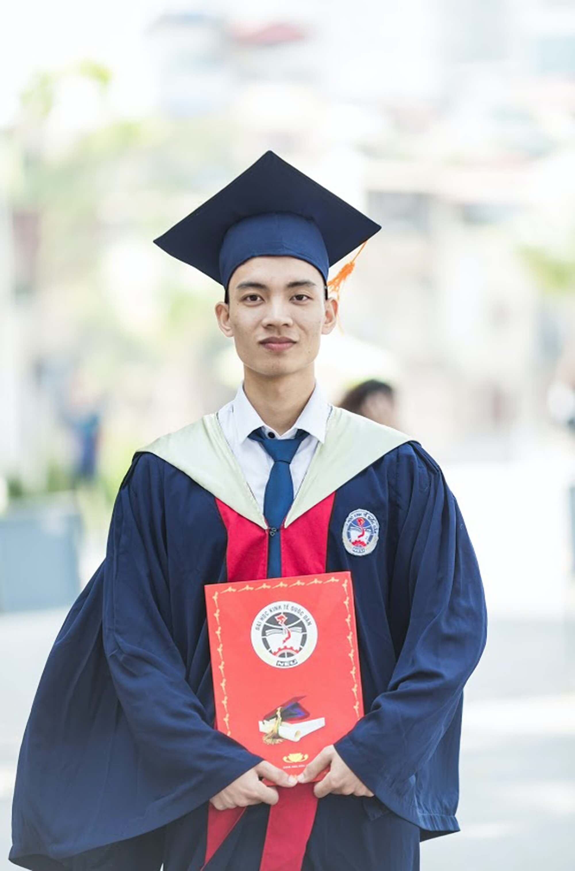 Happy student with report card after graduation